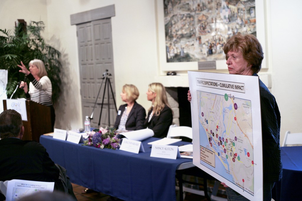 (right to left) Stop Polluting Our Newport board member Nancy Alston holds up a cumulative traffic impact map as the city’s deputy community development director  Brenda Wineski and community development director Kim Brandt listen to SPON board member Dorothy Kraus speak.