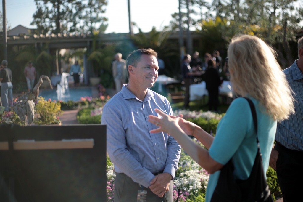 Newport Beach water conservation coordinator Shane Burckle speaks with guests about a city project during the expo. 