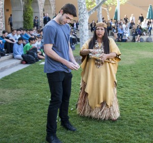 Jacque Tahuka-Nunez and student body president Jack Williamson place fresh sage leaves in a circle around the town square. — Photo by Charles Weinberg