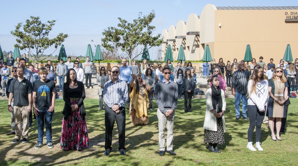 Jacque Tahuka-Nunez (center) and guests form the inner circle during the ritual. The circle includes Lisa Argyros and family, Head of School Gordon McNeill, founding board members, science faculty, students and more.  — Photo by Charles Weinberg