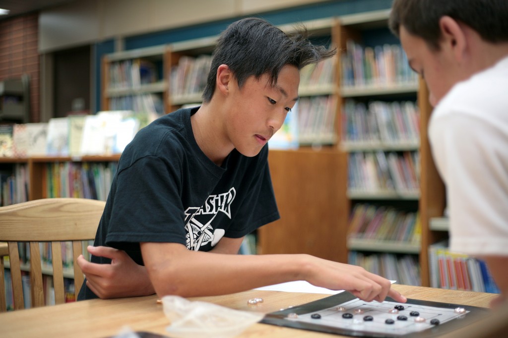 Newport Beach resident and Pegasus School eighth grader Ben Gil, 14, plays Nine Men Morris, a game popular during Shakespeare’s time.