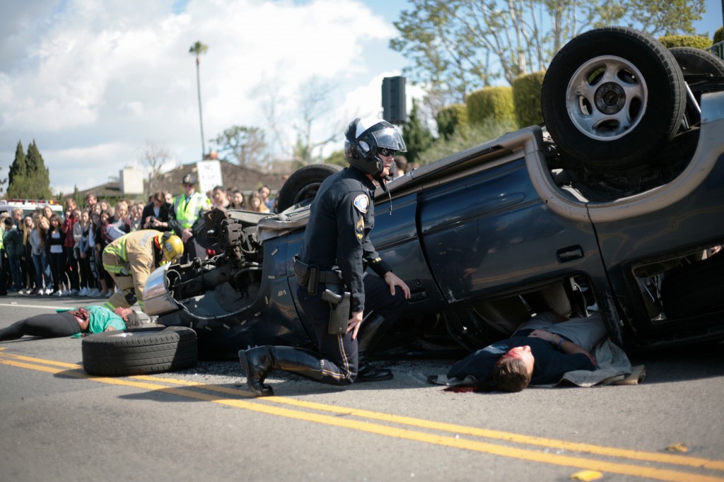 An officer checks on “victim” Ben Palitz during the DUI demonstration. 