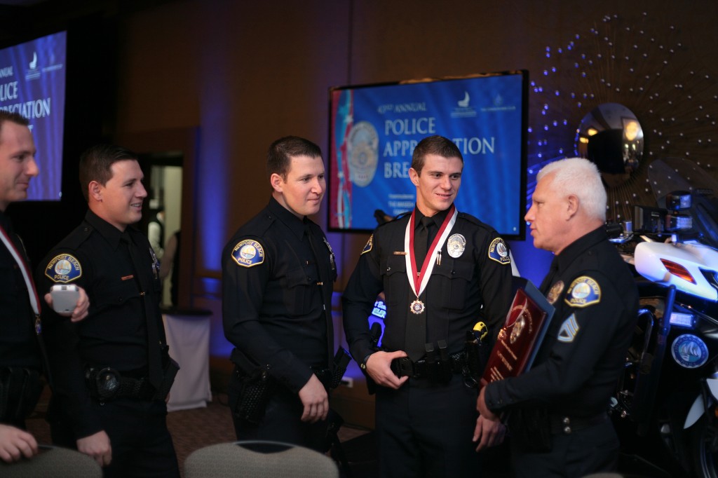 Supervisor of the Year Lloyd Whisenant (far right) talks to other NBPD officers, including Award of Merit winner, Officer Andrei Bratiloveanu (second from right) — Photo by Sara Hall