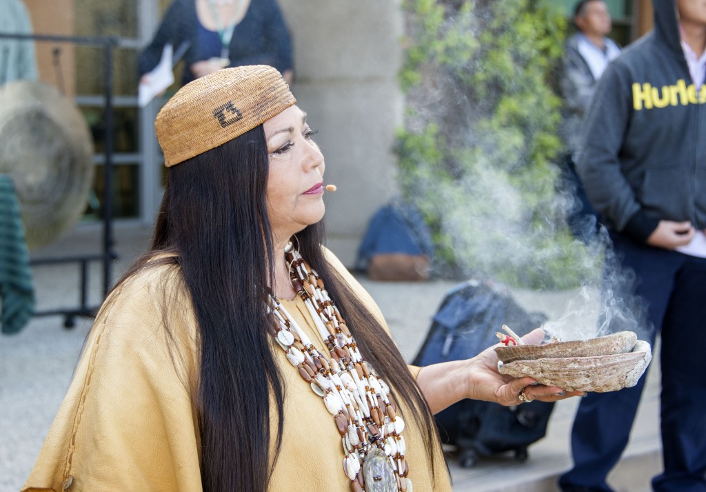 Jacque Tahuka-Nunez, from the Acjachemen Nation of the Juaneno Band of Mission Indians, burns sage as she performs a Native American blessing of the land at Sage Hill School, in conjunction with the construction of the Lisa Argyros and Family Science Center. — Photo by Charles Weinberg