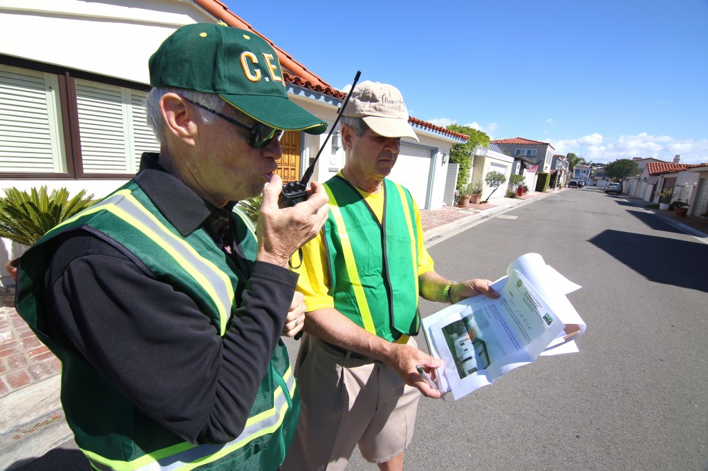 Lido Isle residents Dave Lamb (left) radios in the details of a hypothetical house fire as Hugh Helm checks the incident report during Newport Beach Fire Department’s first ever Community Emergency Response Team multi-neighborhood drill on Saturday. — All photos by Jim Collins ©