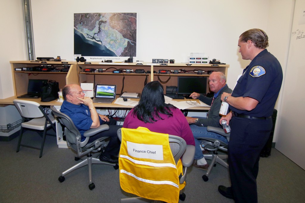 NBFD life safety specialist and CERT program leader, Matt Brisbois (right), talks with volunteers at the city’s Emergency Operations Center during the drill on Saturday.