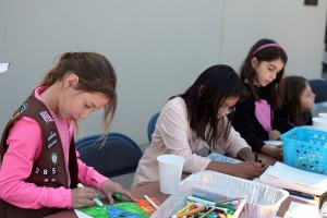 Kids create drawing to include with the sack lunches that went to Lighthouse Ministries