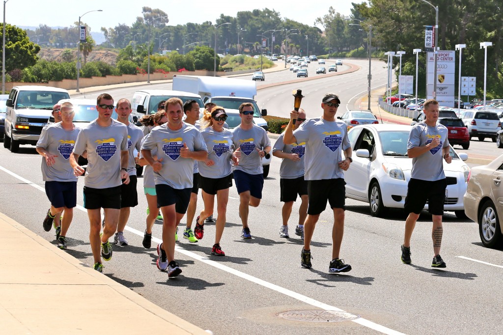 Newport Beach Police Department personnel carry the Flame of Hope as they participate in the Special Olympics Torch Run on Thursday. — Photo by Jim Collins ©