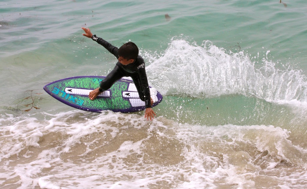 A young boy enjoys the waves at the city’s skimboarding camp last year. — Photo courtesy the city of Newport Beach ©