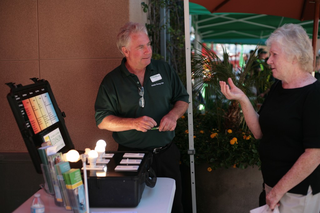 SoCal Edison representative John Fields speaks with Costa Mesa resident Kathleen Whelan about light temperature during the expo on Saturday. — Photo by Sara Hall ©