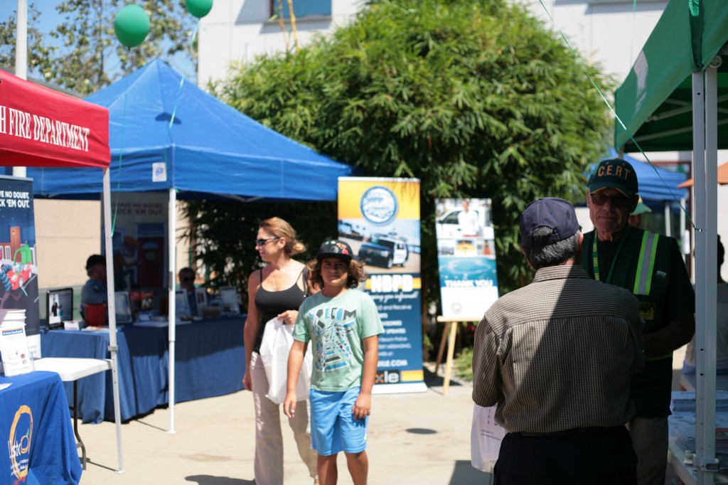 Visitors check out the booths at the expo as a CERT volunteer speaks another guest about preparedness. — Photo by Sara Hall ©