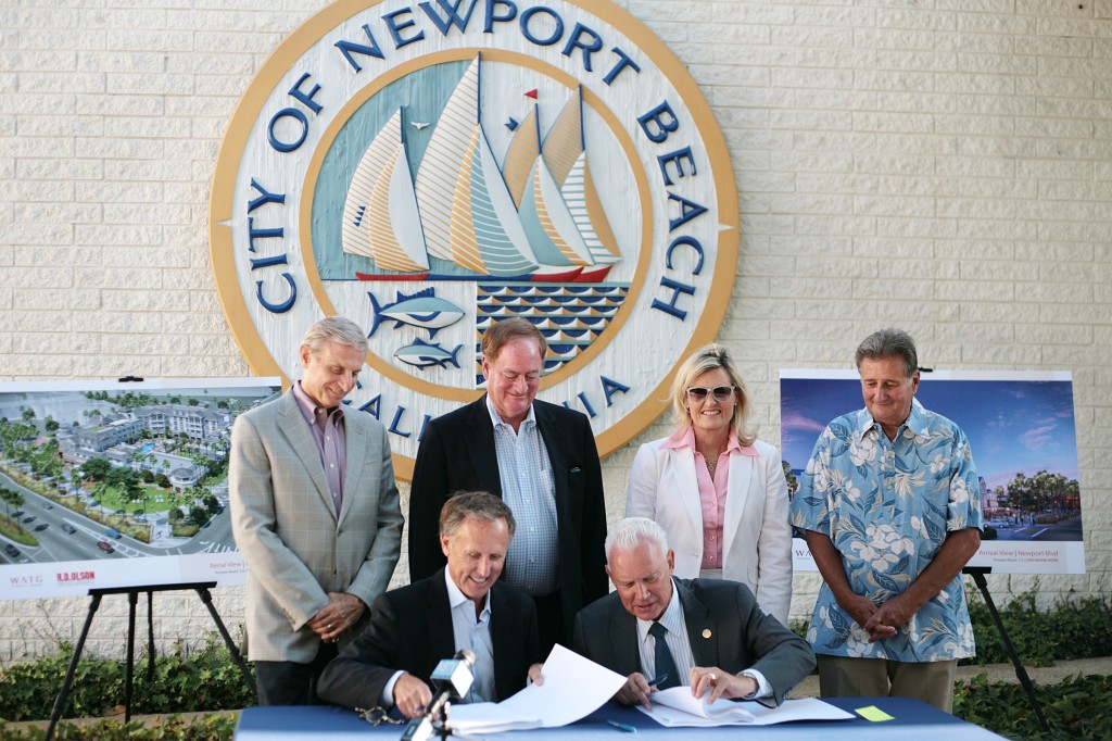 (front, left to right) Developer Bob Olson and Mayor Rush Hill sign the lease for the old city hall site as council members (back row, left to right) Mike Henn, Keith Curry, Leslie Daigle and Mayor Pro Tem Ed Selich watch. — Photo by Sara Hall ©