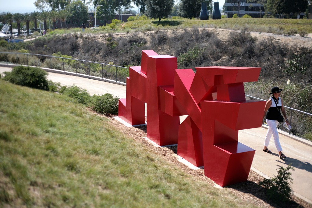 A visitor walks by the large Red Gateway sculpture by Chris Rench at the Civic Center Park on Saturday. — Photo by Sara Hall ©