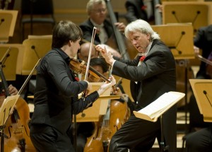 Violinist Joshua Bell performing on stage with Music Director of the Pacific Symphony Carl St.Clair