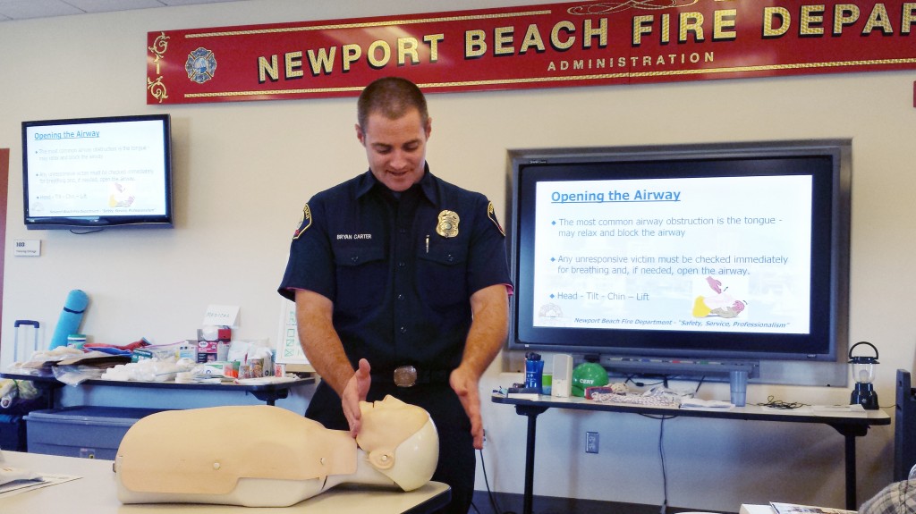 NBFD Paramedic Bryan Carter demonstrates how to clear an airway and perform CPR during a Community Emergency Response Team class in September. — Photo by Sara Hall ©