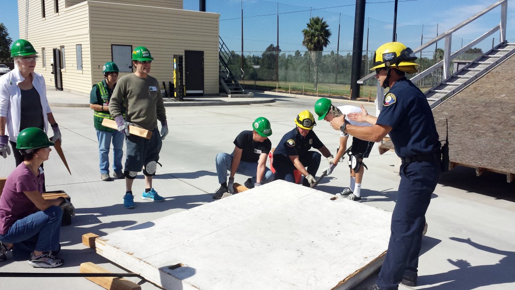NBFD Fire Engineer Richard Ruffini explains the cribbing technique used to lift heavy objects off victims during a CERT training class earlier in the month. — Photo by Sara Hall ©