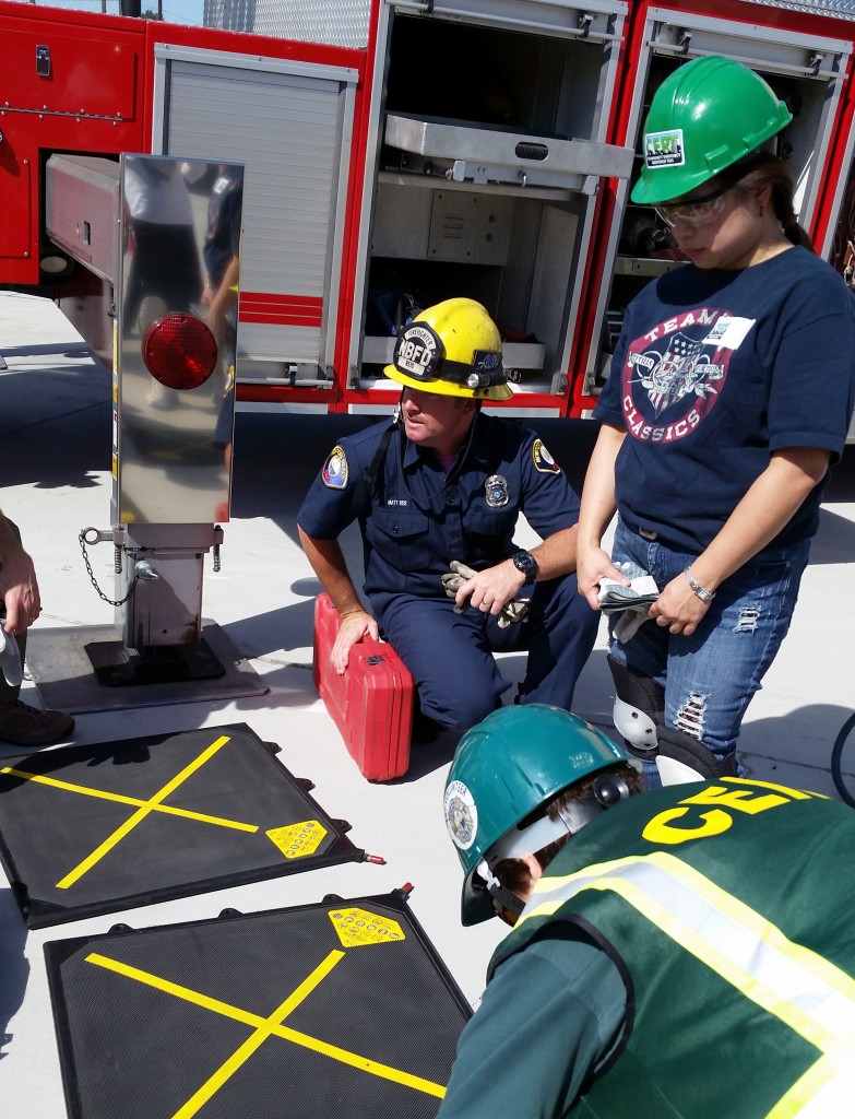 NBFD Firefighter Matt Reis talks with volunteers about equipment during a CERT training class in early October.  — Photo by Tom Ricks ©