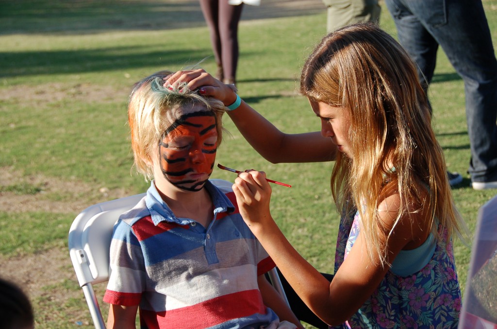 A Mariners Christian School student gets his face painted like a tiger at the Fall Festival on Sunday. — Photo by Debra Biagiotti ©
