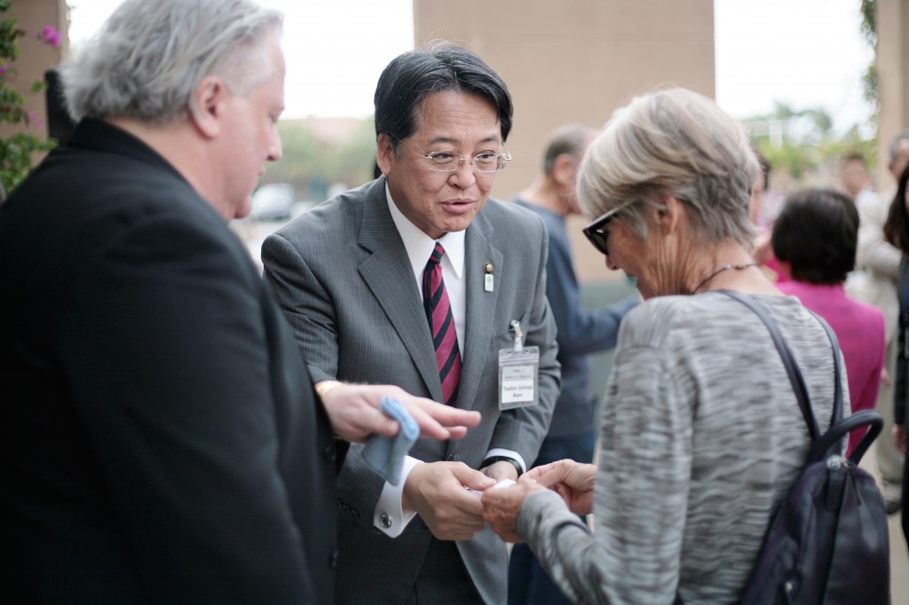 Okazaki, Japan, Mayor Yasuhiro Uchida (middle) greets Newport Beach City Councilwoman Nancy Gardner as Seth Siegel of the Sister City Association helps translate. — Photo by Sara Hall ©