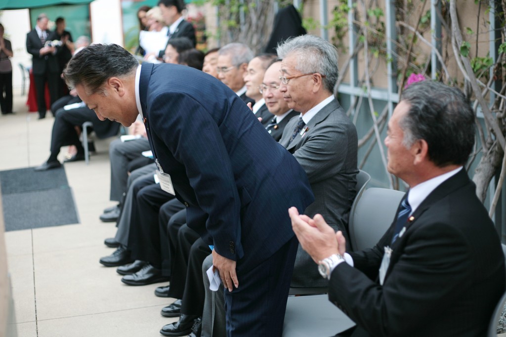 Okazaki City Council Member Toshimitsu Shibata bows as he is being introduced to the crowd during the Sister City ceremony. — Photo by Sara Hall ©