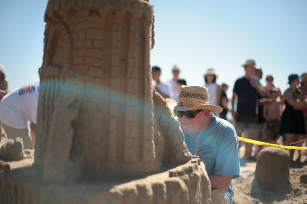 Bob Lank of Mission Viejo works on a sandy structure for his team, the Sand Crabs, during the 53rd Annual Sandcastle Contest on Sunday, presented by the Commodore’s Club of the Newport Beach Chamber of Commerce. The Sand Crabs (and their secondary entry, Sand Crabs Too) ended up winning the People’s Choice Award for Best Creation and second place for Most Unique Sandcastle. — Photo by Sara Hall ©