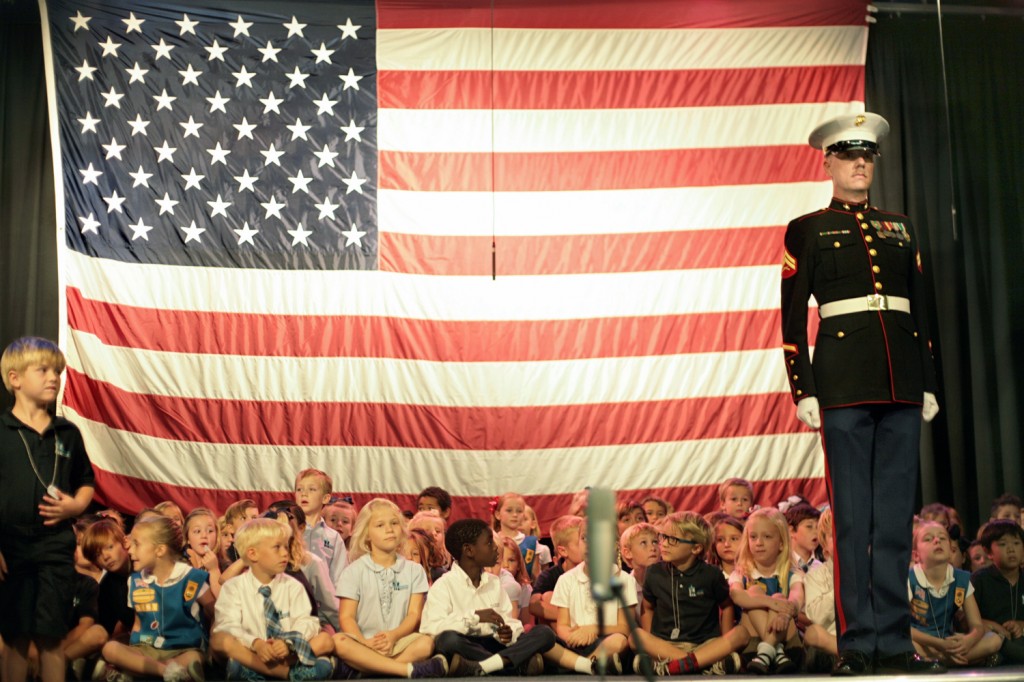 Dwight Hanson, U.S. Marine Corps retired and MCS Boy Scouts, leads the posting of the colors during the special Veterans Day all-school chapel service at Mariners Christian School on Tuesday. — Photo by Sara Hall