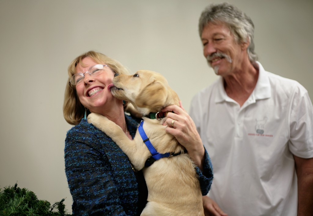 Cathy Ehlers Metcalf meets Freedom Dog-in-training, Walter’s Honor. The puppy was named after her father, Walter Ehlers, who earned the Medal of Honor for his work on D-Day. Ehlers died February 20. He was 92. — Photo by Sara Hall