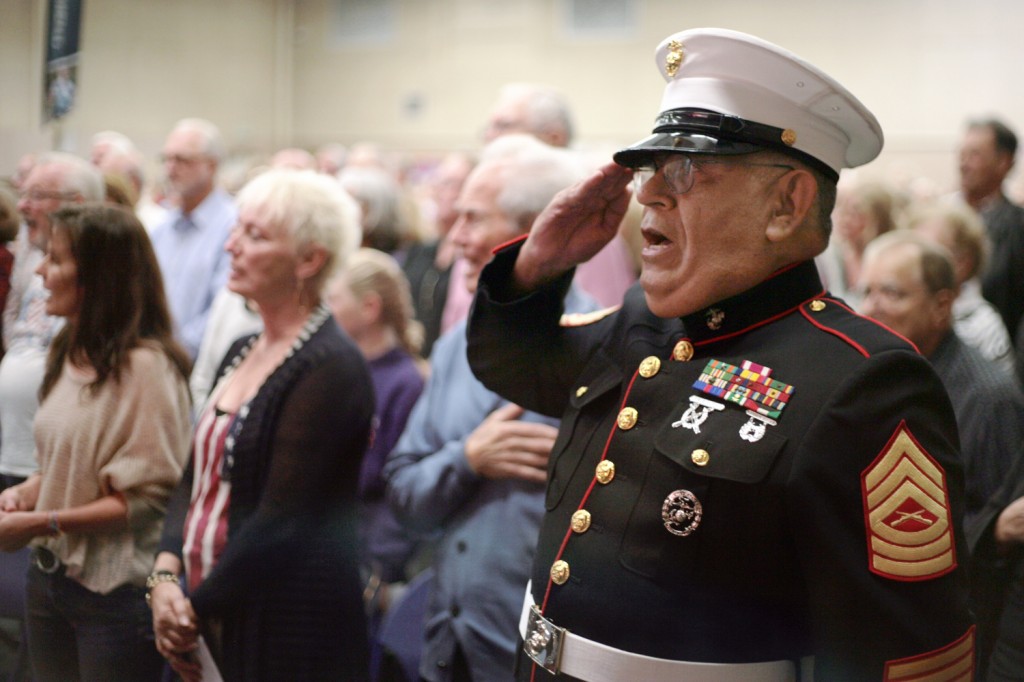 Veteran Jesus Rivera of Irvine salutes as he sings the national anthem during the event. The Texan native served in the U.S. Marines from 1970 to 2000.  — Photo by Sara Hall