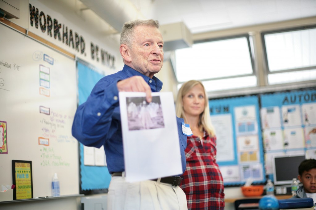 Korean War veteran Stan Cohen shows the class a photo of the Korean War Veterans Memorial in Washington D.C.  — Photo by Sara Hall ©