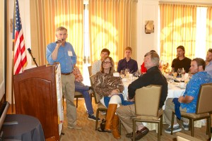 Pete Melvin speaks to the crowd at the luncheon, including his team at Morrelli and Melvin Design and Engineering, Inc., with Gino Morrelli sitting front and center. Photo by Jim Collins.