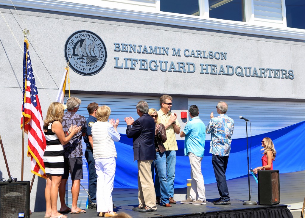 Newport Beach City Council members and other VIPs applaud the unveiling of the Benjamin M Carlson Lifeguard Headquarters. — NB Indy Photo ©