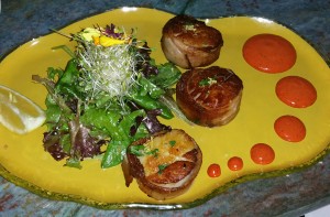 Pan seared diver scallops wrapped in triple smoked apple wood bacon served with achiote aioli, at Fly 'N' Fish