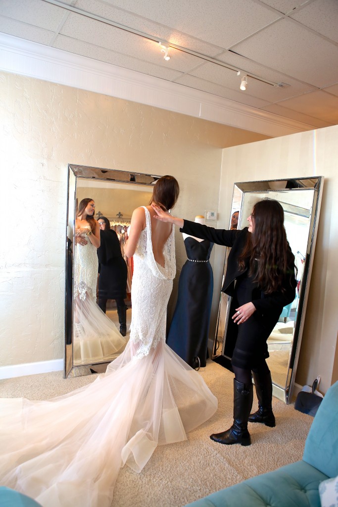 A bride-to-be tries on a wedding dress during the March 8 Corona del Mar bridal walk, which drew numerous brides, bridesmaids, grooms, and others to wedding-oriented shops in Corona del Mar. — Photo by Jim Collins ©