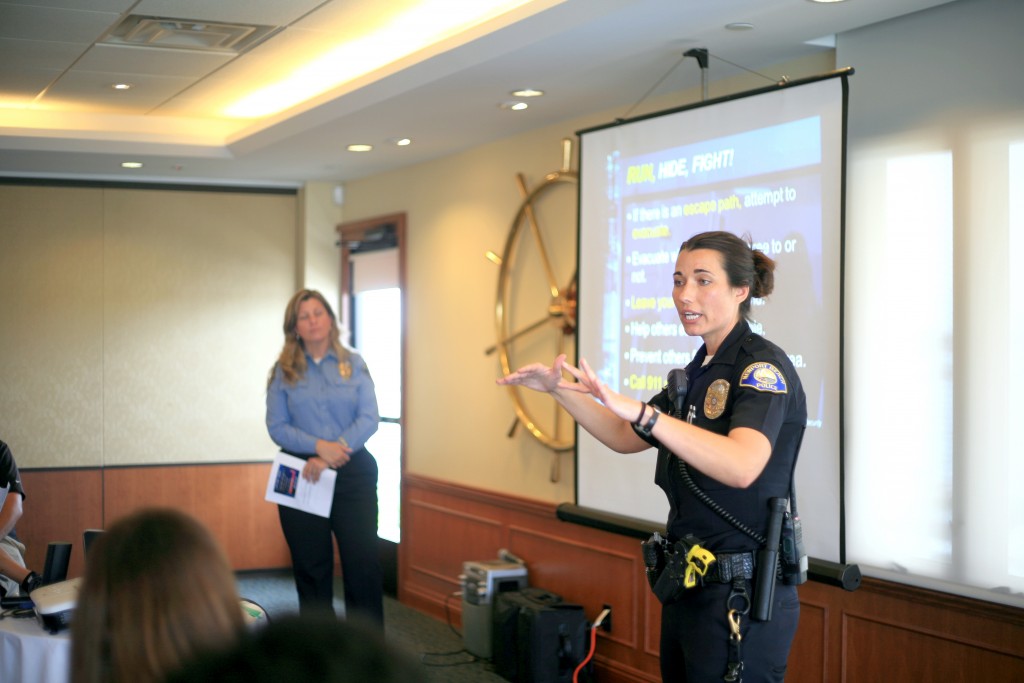 Newport Beach Police Department officer and School Resource Officer Marie Gamble talks about what to do in an active shooter situation while NBPD Crime Prevention Specialist Andi Querry listens in the background during the Chamber of Commerce’s lecture on Wednesday. — Photo by Sara Hall ©