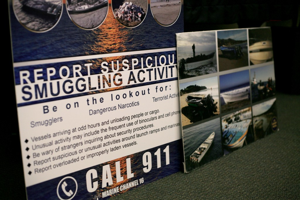 An informational graphic about smuggling activity warning signs was on display during the meeting. — Photo by Sara Hall ©