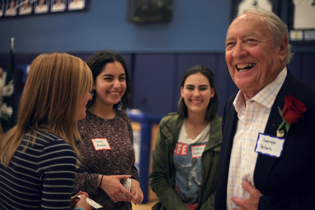 Korean War veteran George Peters laughs with his group of Corona del Mar High School students during the Living History program at the school last week. — Photo by Sara Hall ©