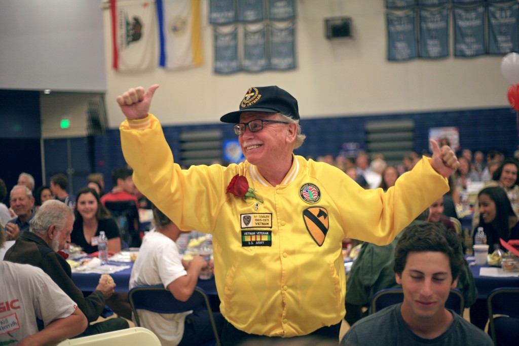 Vietnam veteran Ronnie Guyer waves hello to the crowd a his group of students introduce him. — Photo by Sara Hall ©