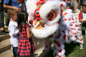 Dancers from the Ane Thanh troupe get the crowd involved as they perform a traditional Chinese lion dance. — Photo by Sara Hall ©