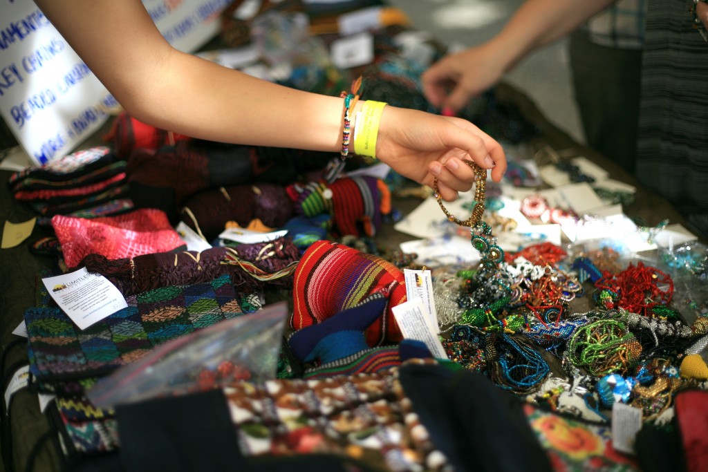 Festival guests look through handmade jewelry sold during the event at the ethnic bazaar. Proceeds benefit Limitless Horizons Ixil, a nonprofit that works to create opportunities for the indigenous youth, women, and families of Chajul, Guatemala. — Photo by Sara Hall ©