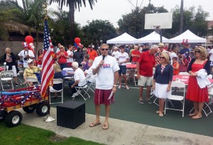 Former Mayor Mike Henn addresses the crowd at a 2013 Balboa Peninsula Fourth of July event