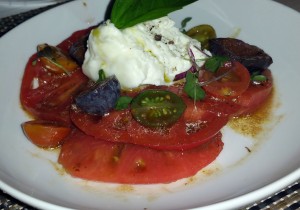 Burrata and heirloom tomato caprese with fig and basil, and 18 year balsamic vinegar