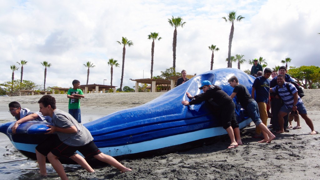 Children from the Speech and Language Development Center help push a giant floating whale into the Newport Dunes lagoon.   — Photo by Jenna Satariano ©