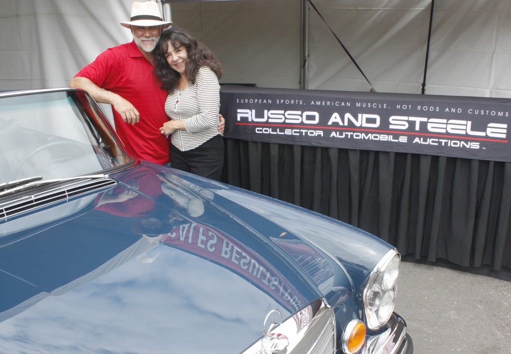 Russo and Steele owners Drew and Josephine Alcazar with a 1971 Mercedes 220 SE convertible that goes on the auction block this weekend at Newport Dunes. — NB Indy photo ©