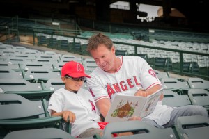 Former Angels star pitcher Chuck Finley of Newport Beach reads to a second grader during the “Readers in the Outfield” event 
