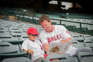 Former Angels star pitcher Chuck Finley of Newport Beach reads to a second grader during the “Readers in the Outfield” event