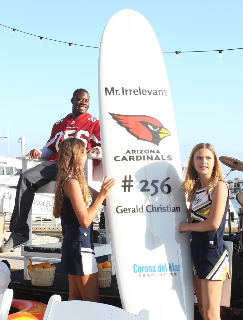 The gift of a surfboard for Mr. Irrelevant, Gerald Christian. — Photo by Jim Collins ©