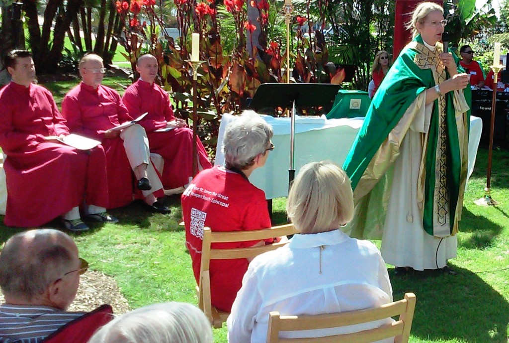 St. James the Great Church holds its Sunday service in a park near the locked church building. — Photo by Gina Dostler ©