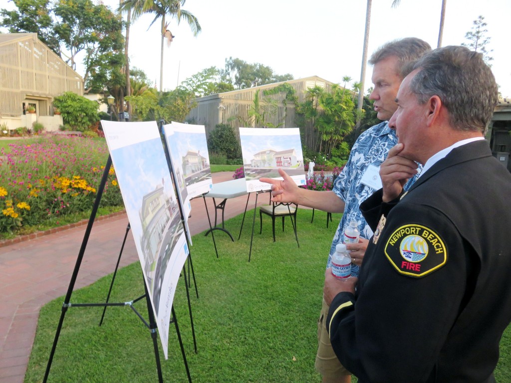 Newport Beach City Councilman Scott Peotter (left) and NB Fire Chief Scott Poster view and discuss the options for the Corona del Mar fire station and library project at a community meeting Monday. — Photo by Sara Hall ©