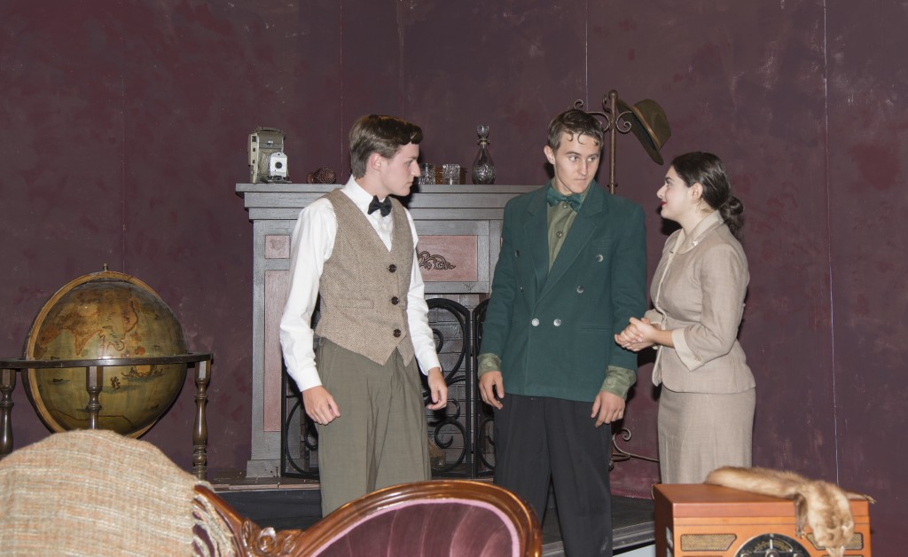 (left to right) NHHS student director and actor Chris Surridge, a junior, and senior actors Race Chambers and Vita Muccia perform a scene from “The Mousetrap.” — Photo by Charles Weinberg