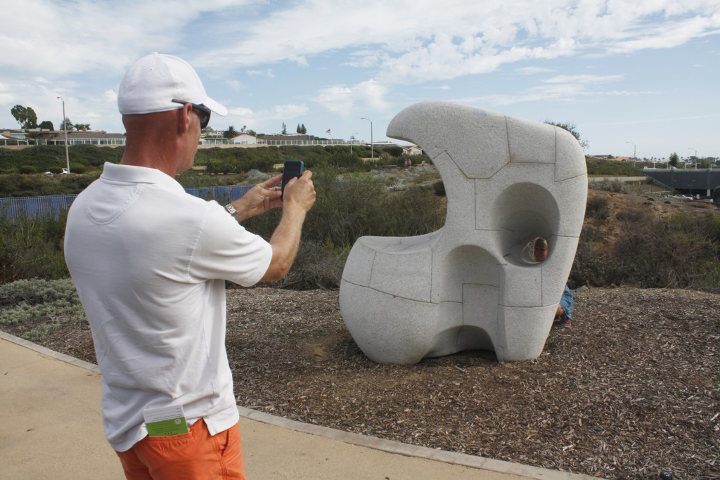 Matt Hagemann of Newport Beach with daughter Hillary, 8, posing in the “Pebble Series” sculpture.  — Photo by Christopher Trela ©